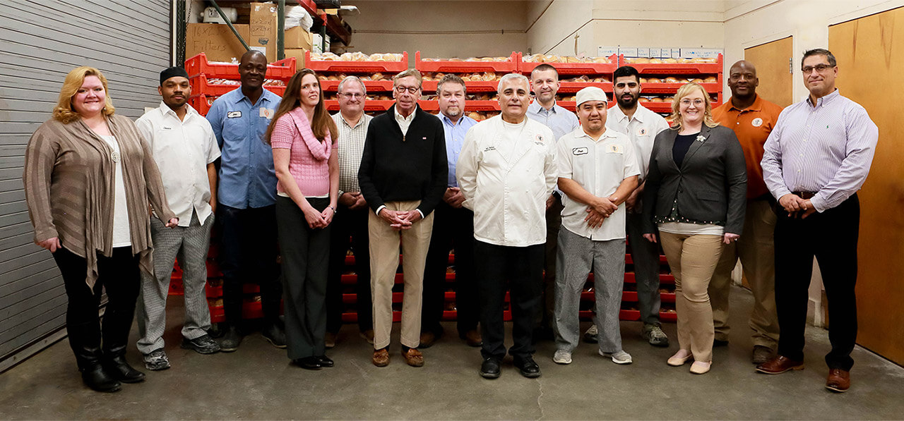 The Neomonde Bakery team and family inside their production facility in Morrisville, NC.